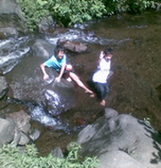 Anugerah plays in water of Coban Rondo waterfall