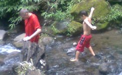 Anugerah at the river of Coban Ondo waterfall Batu