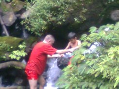 Anugerah is helped by his big friend at Coban Ondo waterfall